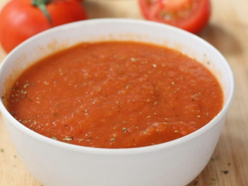 Kom geroosterde tomatensoep met verse basilicum